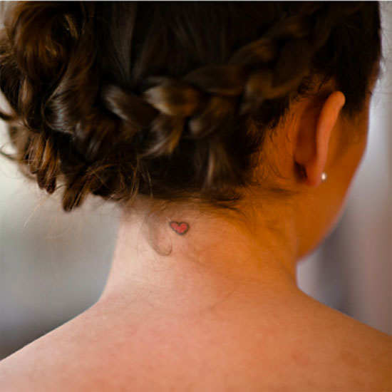 Tiny heart tattoo on neck