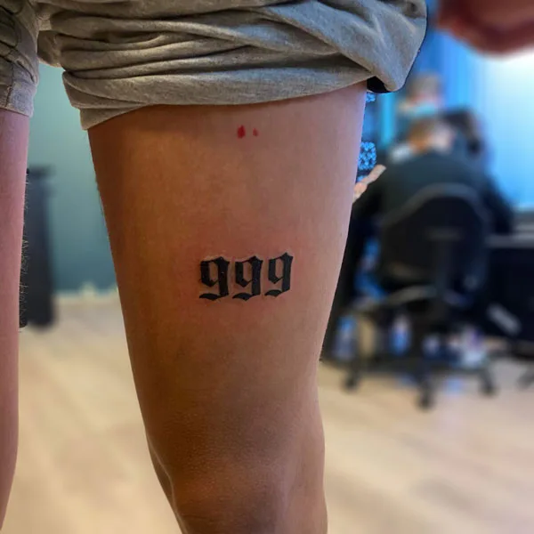 999 tattoo on leg 3