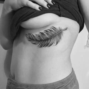 Feather tattoo under breast 1