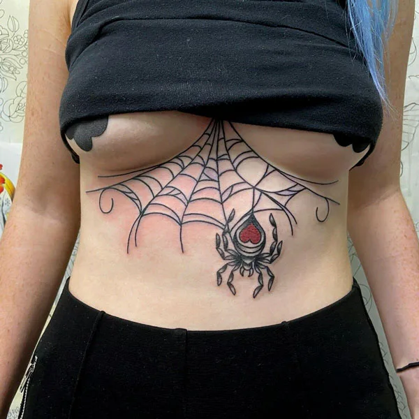 Spider web under boob tattoo