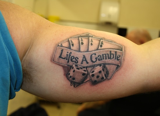 lifes a gamble tattoo on bicep