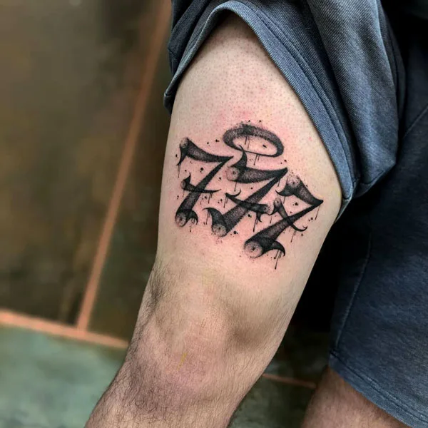 Above knee 777 tattoo
