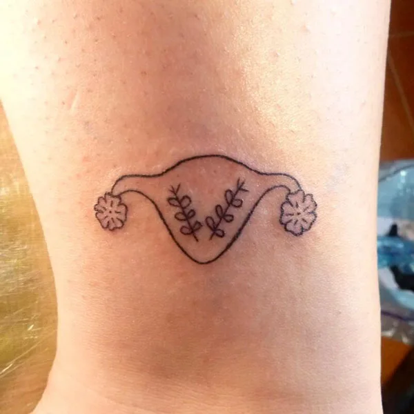 Simple womb tattoo