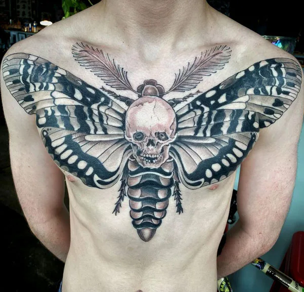 Death moth chest tattoo