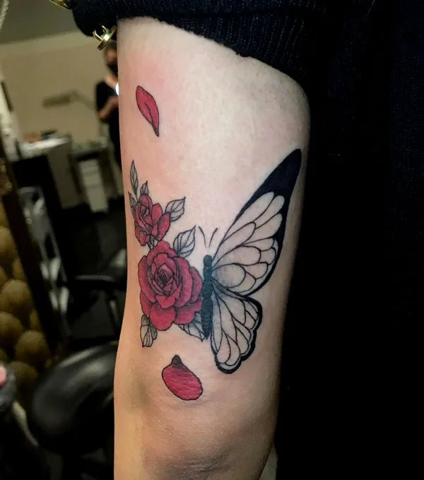 Half butterfly half flower arm tattoo