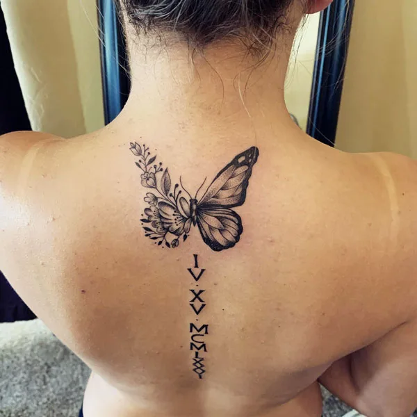 Half butterfly half flower back tattoo