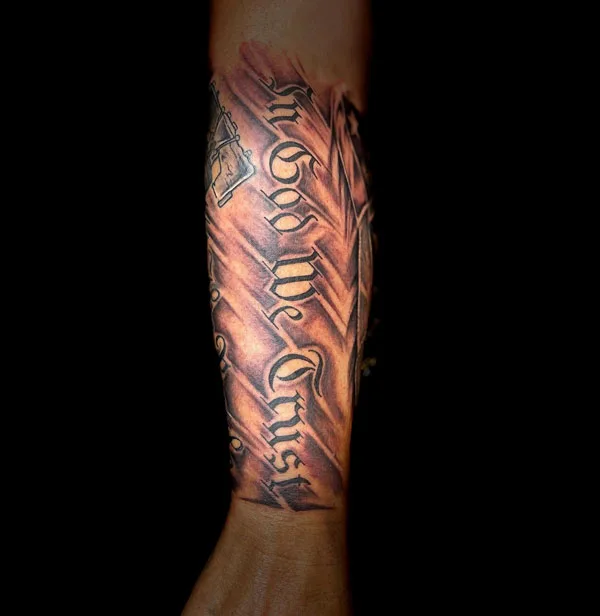 In god we trust forearm tattoo