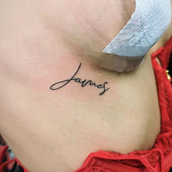 Name tattoo under breast