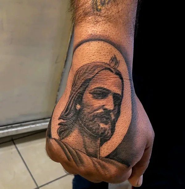 San Judas tattoo on hand