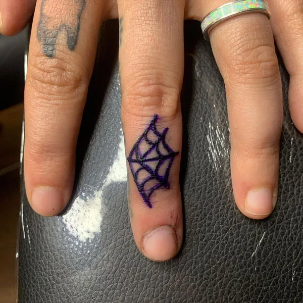 Spider web finger tattoo
