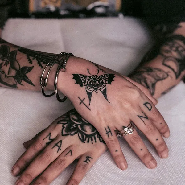 Traditional butterfly hand tattoo