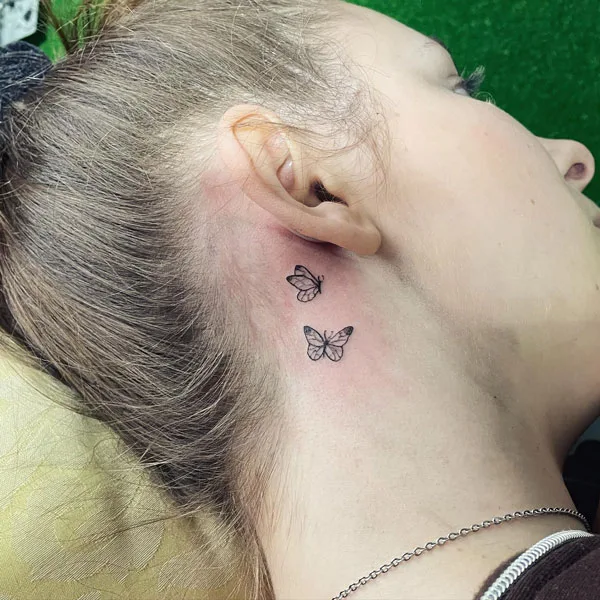 Small butterfly tattoo behind ear