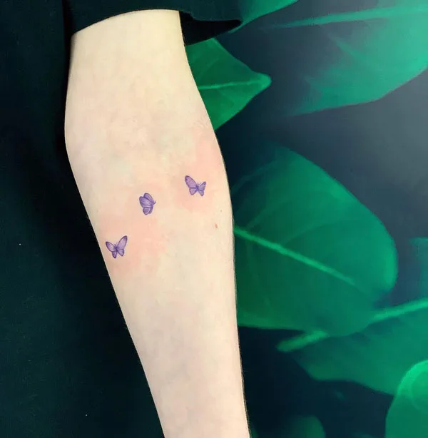Small purple butterfly tattoo