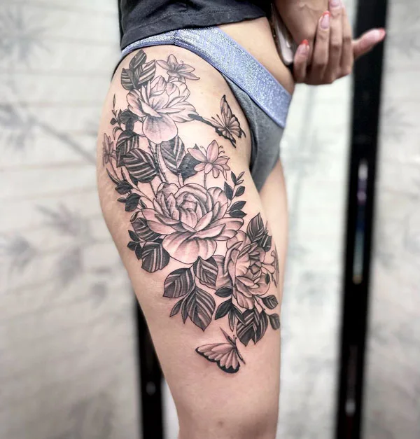 Floral butterfly thigh tattoo