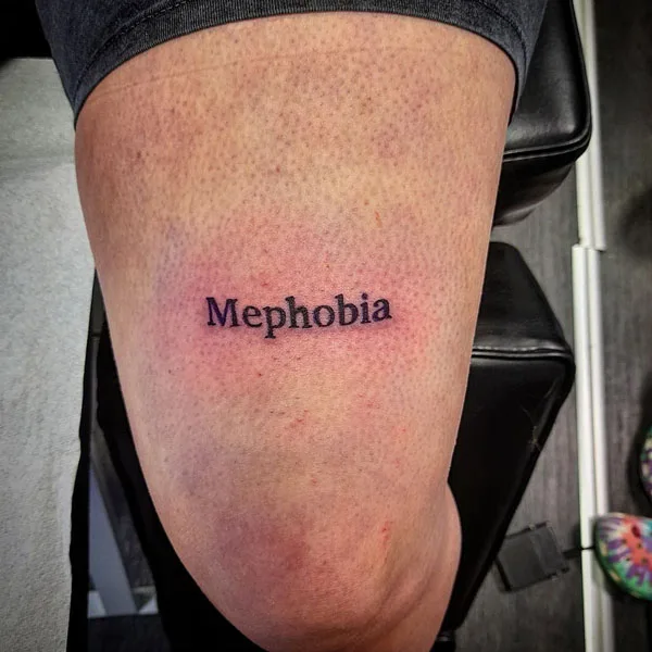 Mephobia above the knee tattoo