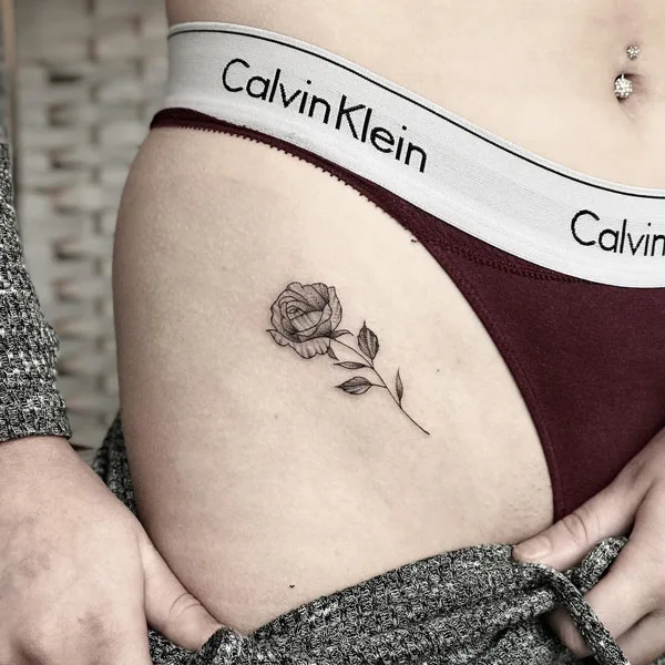Bikini line rose tattoo