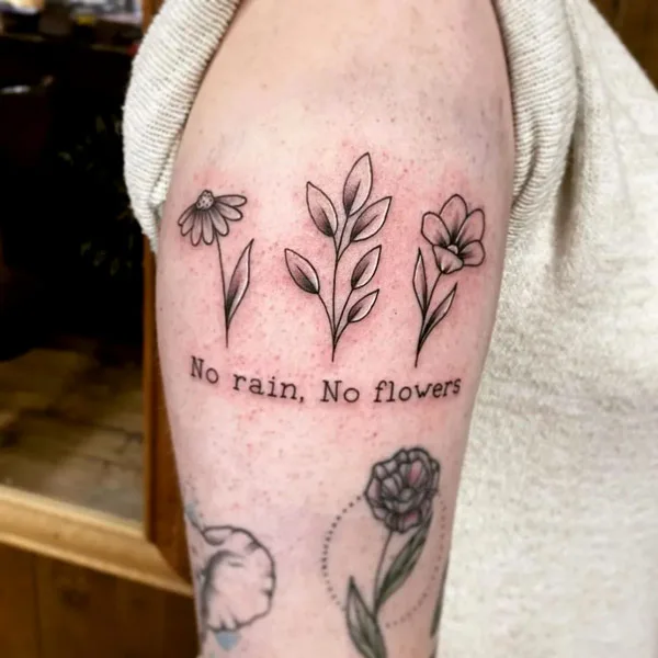 No rain no flowers arm tattoo