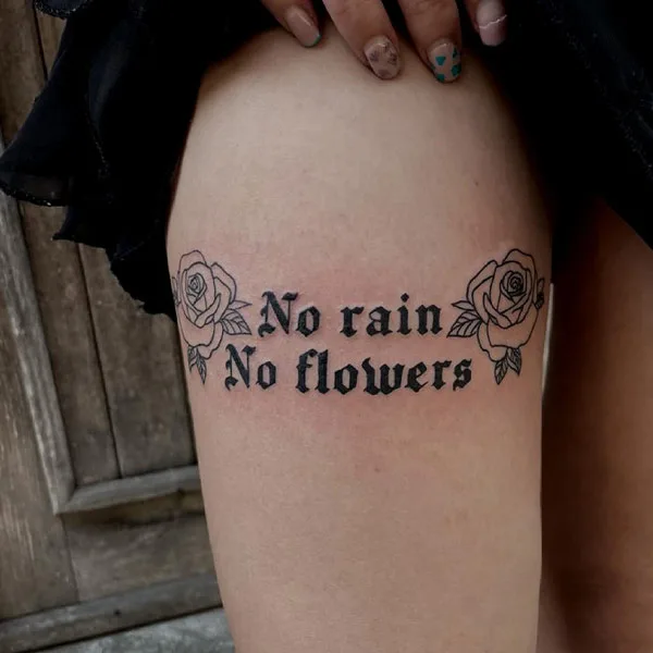 No rain no flowers thigh tattoo