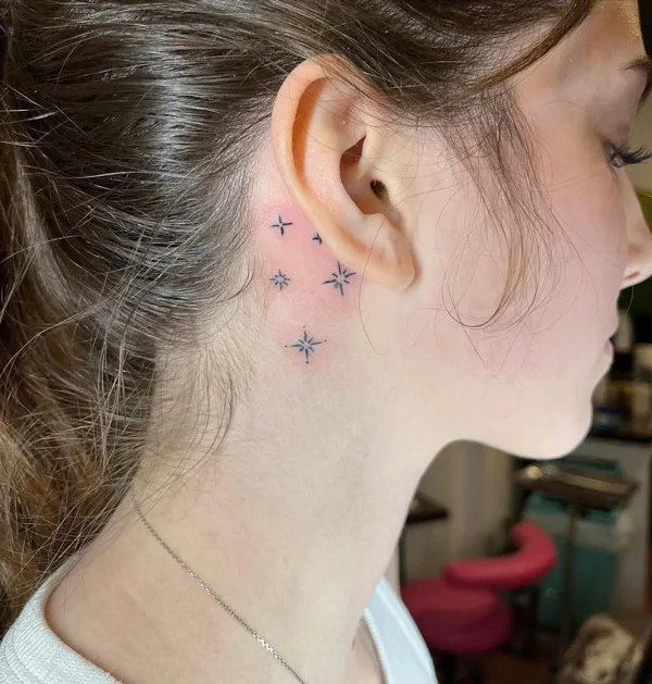 Behind the ear sparkle tattoo
