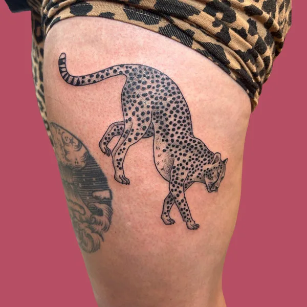 Cheetah thigh tattoo