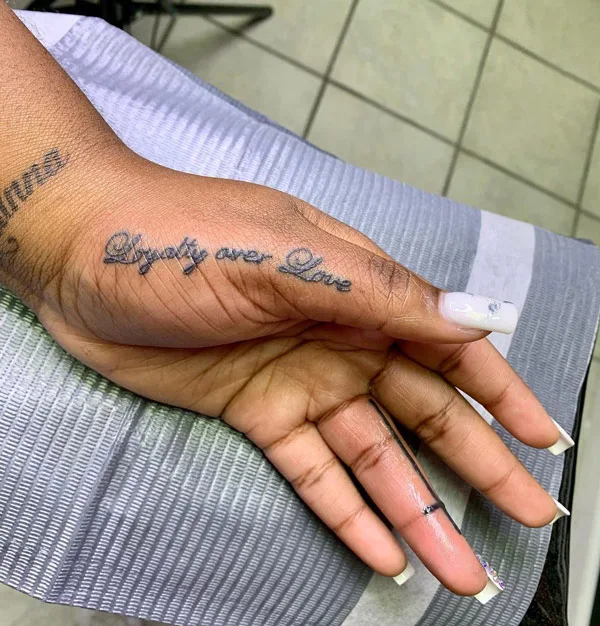 Loyalty over love tattoo on hand