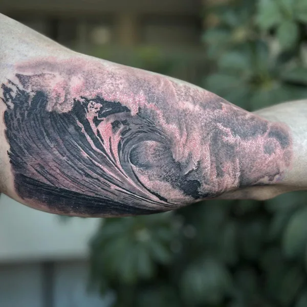 Ocean wave tattoo on bicep