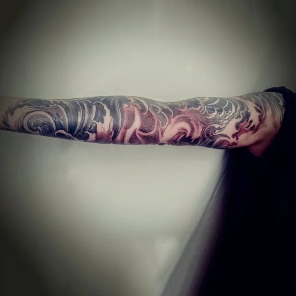 Ocean wave tattoo on sleeve