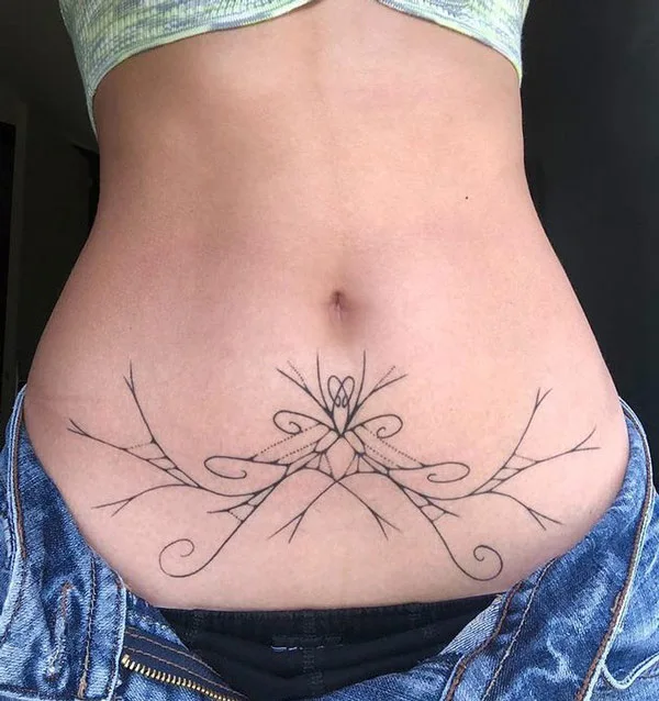 Under belly button tattoo