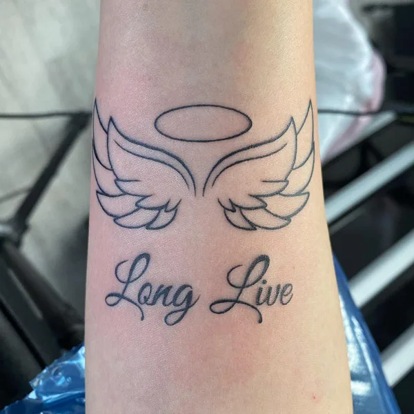 Minimalistic angel wings and halo tattoo located on the