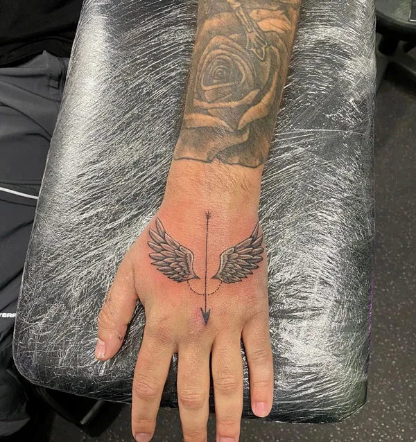 Angel wings tattoo on hand 1