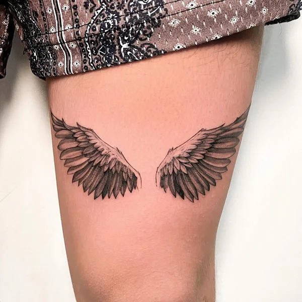 Angel wings tattoo on thigh