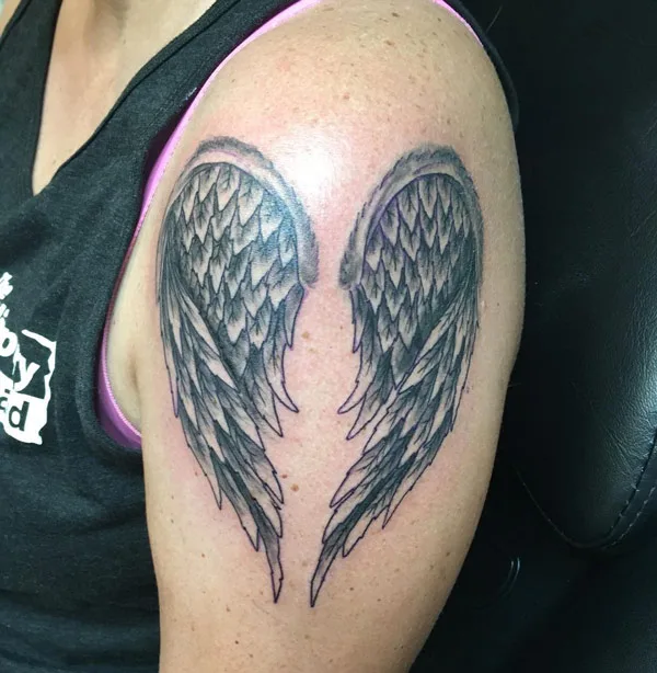 Black angel wings tattoo