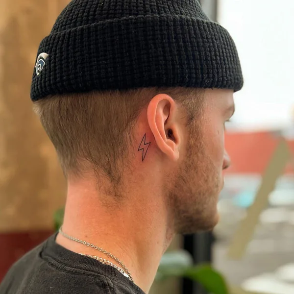 Lightning bolt tattoo behind ear