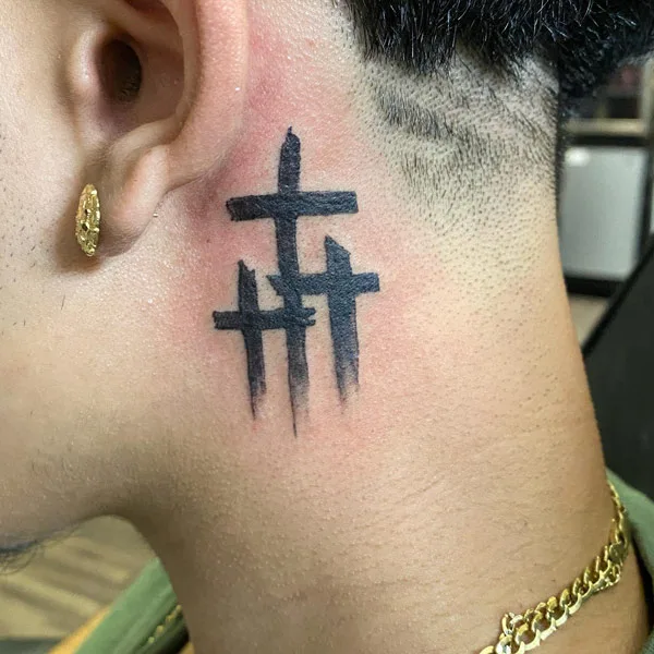 Minimalistic wave and cross tattoo located on the back