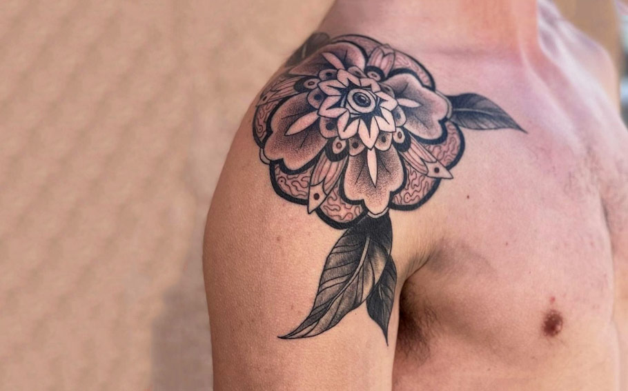 Tea plant tattoo on the left shoulder blade