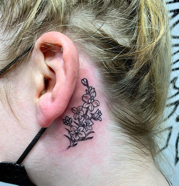 Larkspur Tattoo Behind the Ear